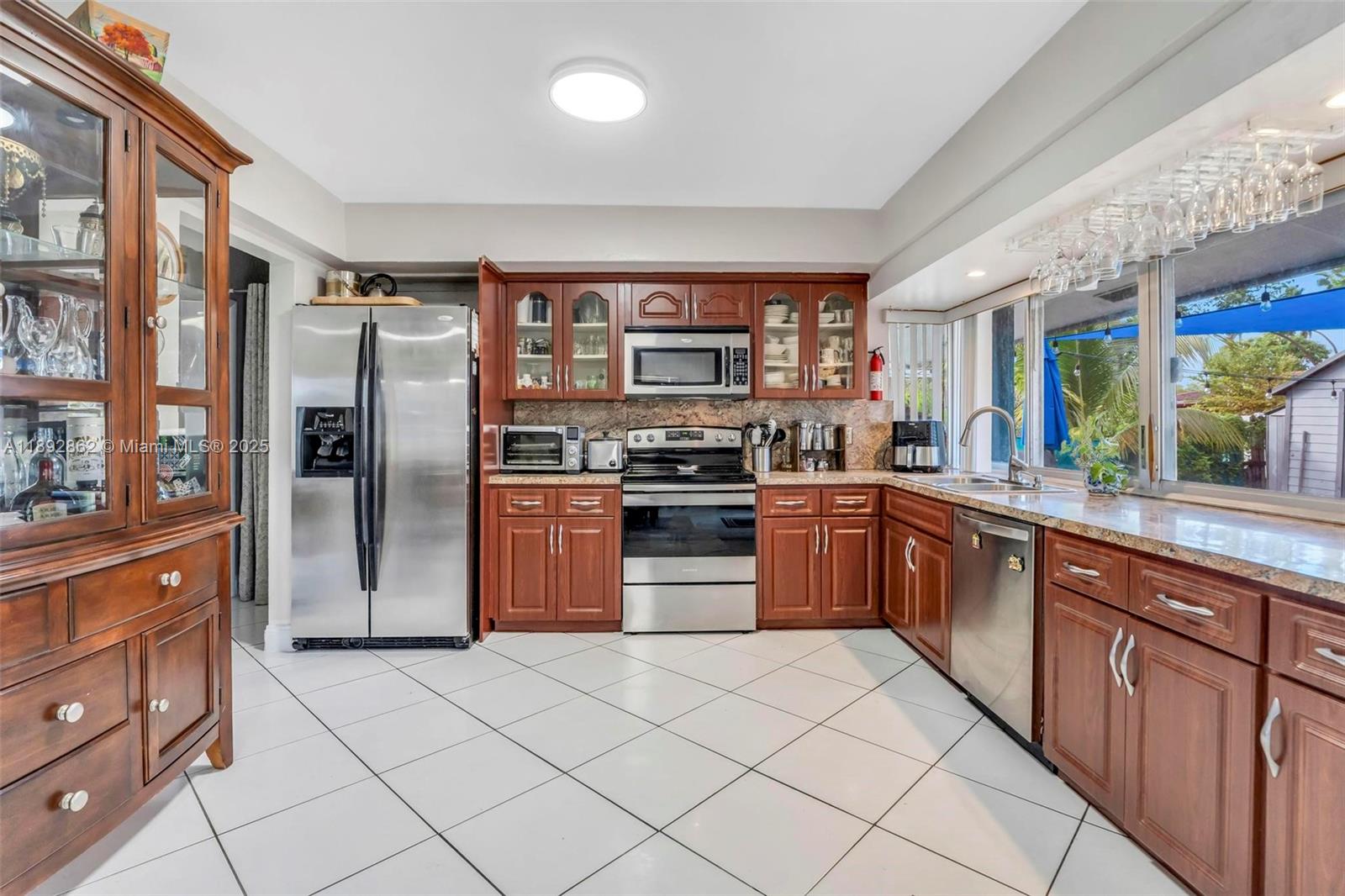 8111 Southwest 205th Street Cutler Bay, FL 33189 - Photo 9 of 51 a kitchen with stainless steel appliances granite countertop a refrigerator and a stove