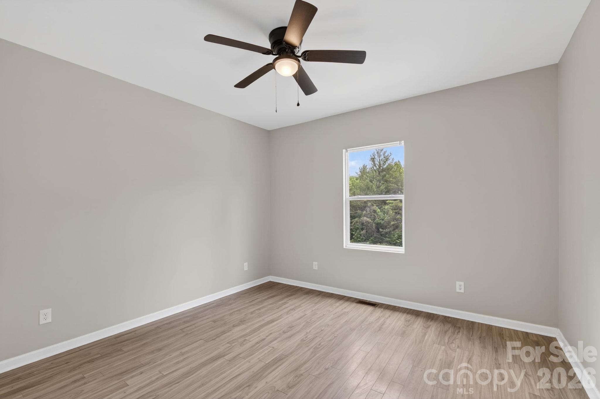 2119 South Road Morganton, NC 28655 - Photo 36 of 47 an empty room with a window and a ceiling fan