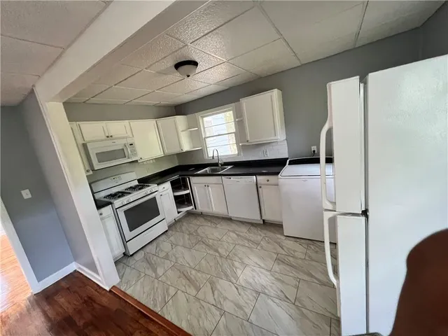 a kitchen with a refrigerator a stove a microwave and cabinets