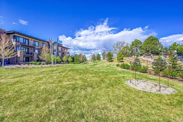 a wooden bench sitting in the middle of a yard