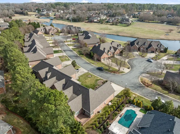 an aerial view of a house with garden space and ocean view