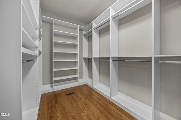 a view of walk in closet with empty racks