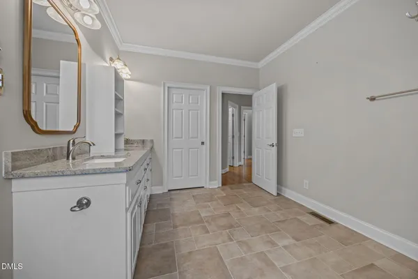 a bathroom with a granite countertop sink a mirror and a shower