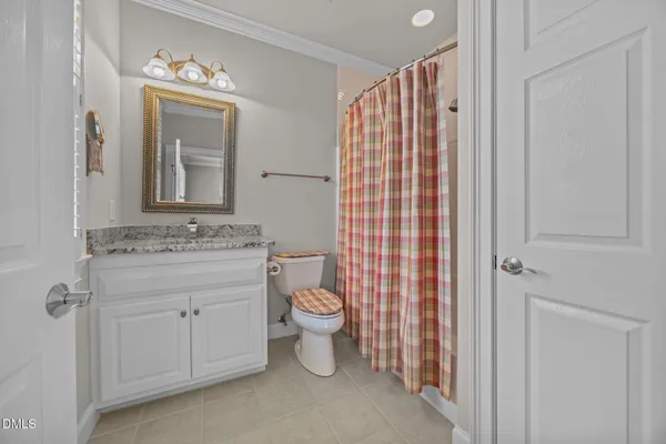 a bathroom with a double vanity sink toilet and shower