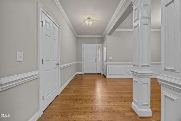a view of a hallway with wooden floor and staircase