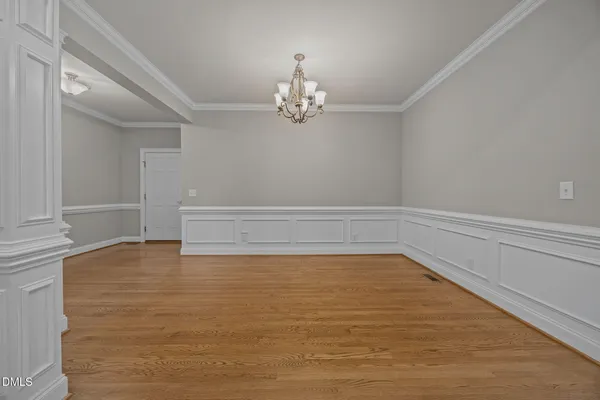 a view of an empty room with chandelier