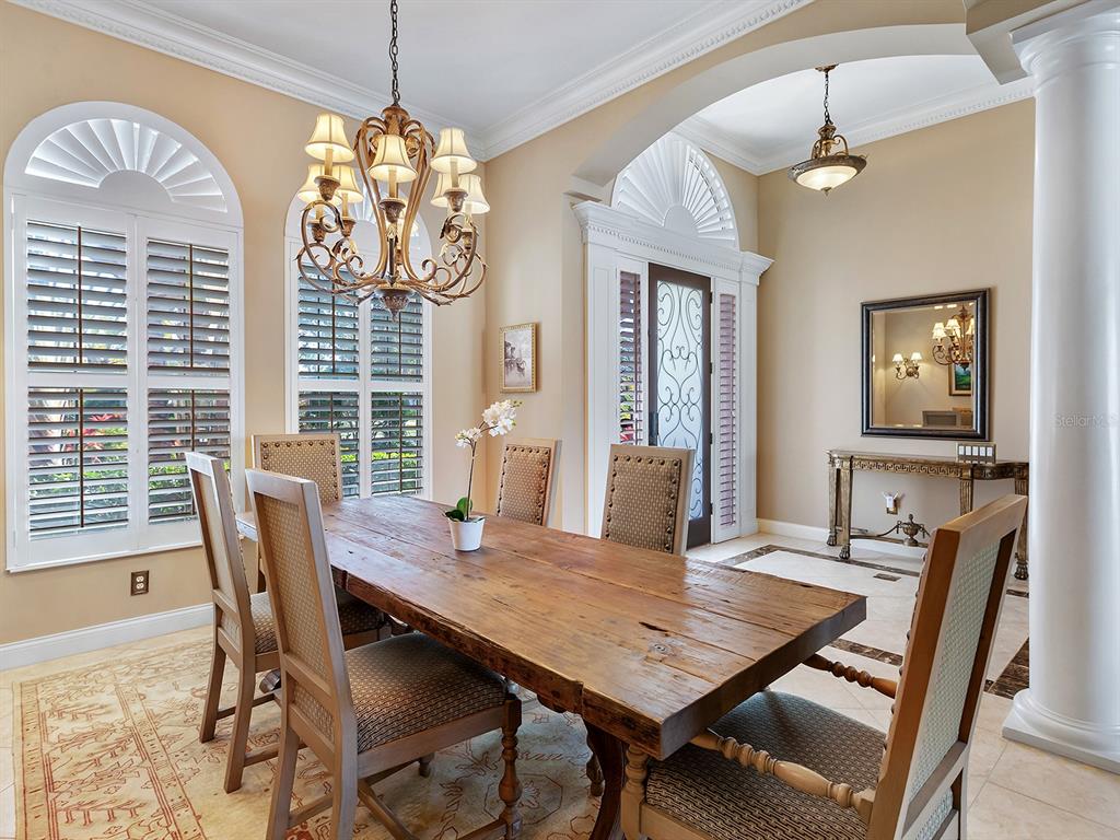 10528 Cheval Place Lakewood Ranch, FL 34202 - Photo 16 of 71 a view of a dining room with furniture window and wooden floor