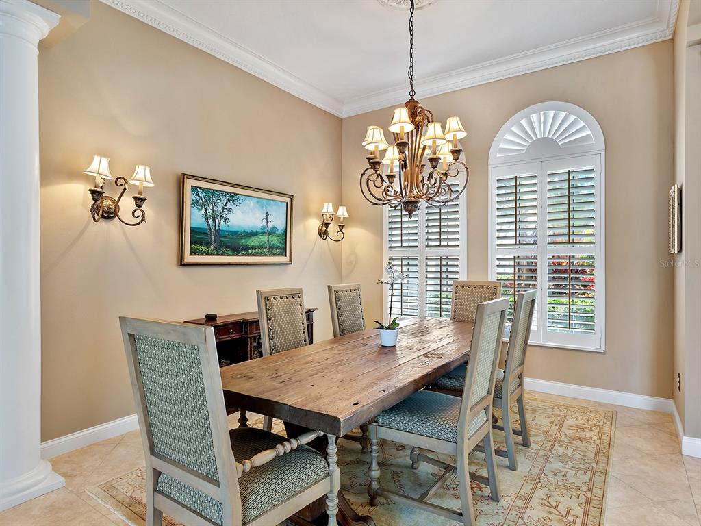 10528 Cheval Place Lakewood Ranch, FL 34202 - Photo 17 of 71 a view of a dining room with furniture window and wooden floor