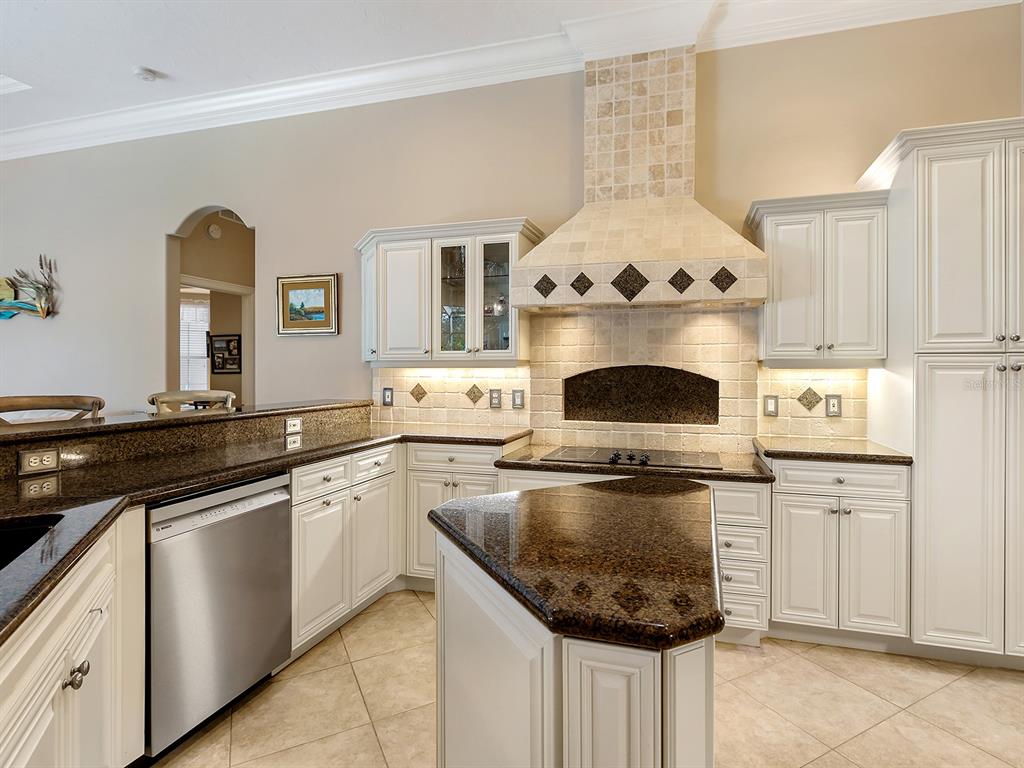 10528 Cheval Place Lakewood Ranch, FL 34202 - Photo 20 of 71 a kitchen with granite countertop a stove and a sink