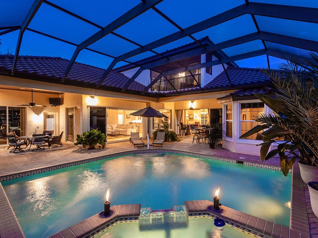 10528 Cheval Place Lakewood Ranch, FL 34202 - Photo 2 of 71 a view of a swimming pool with an outdoor seating