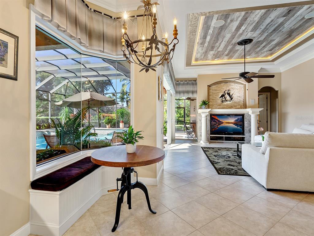 10528 Cheval Place Lakewood Ranch, FL 34202 - Photo 25 of 71 a living room with furniture a fireplace and a table