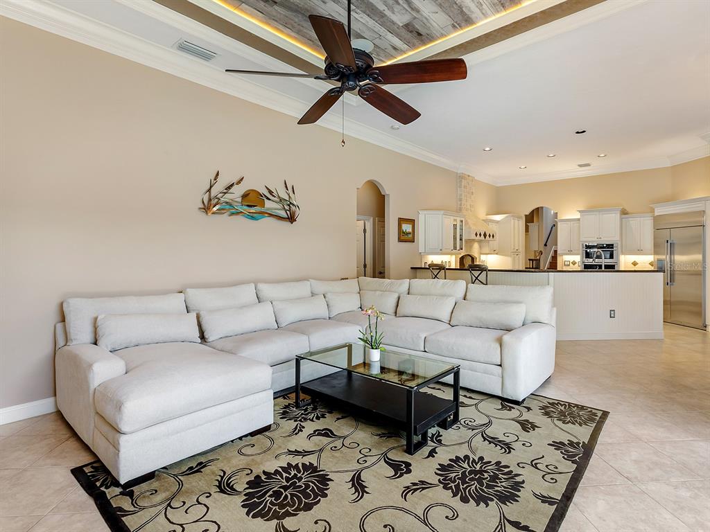 10528 Cheval Place Lakewood Ranch, FL 34202 - Photo 28 of 71 a living room with furniture and kitchen view