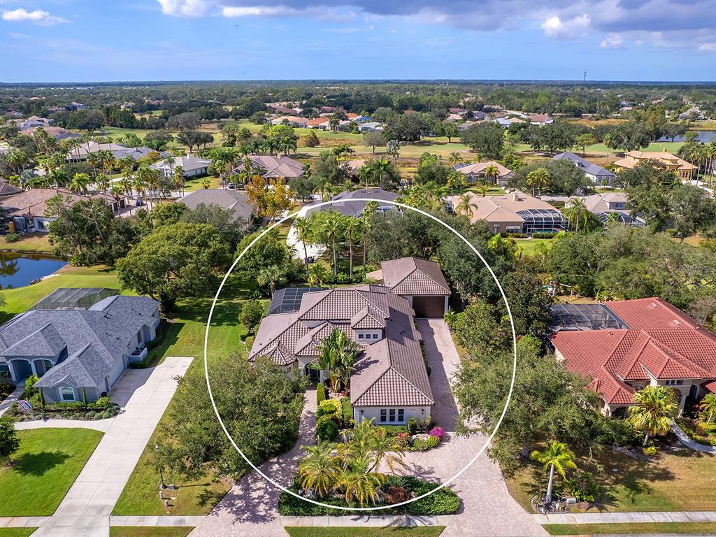 10528 Cheval Place Lakewood Ranch, FL 34202 - Photo 3 of 71 an aerial view of residential houses with outdoor space and trees