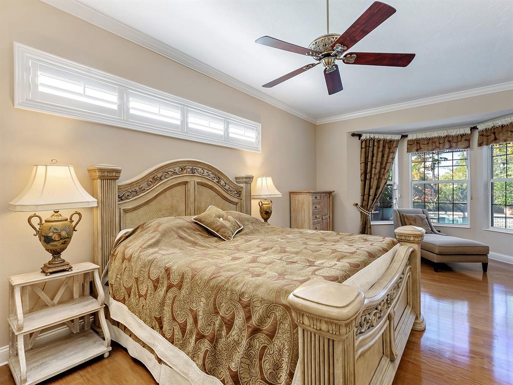 10528 Cheval Place Lakewood Ranch, FL 34202 - Photo 31 of 71 a bedroom with a bed and wooden floor