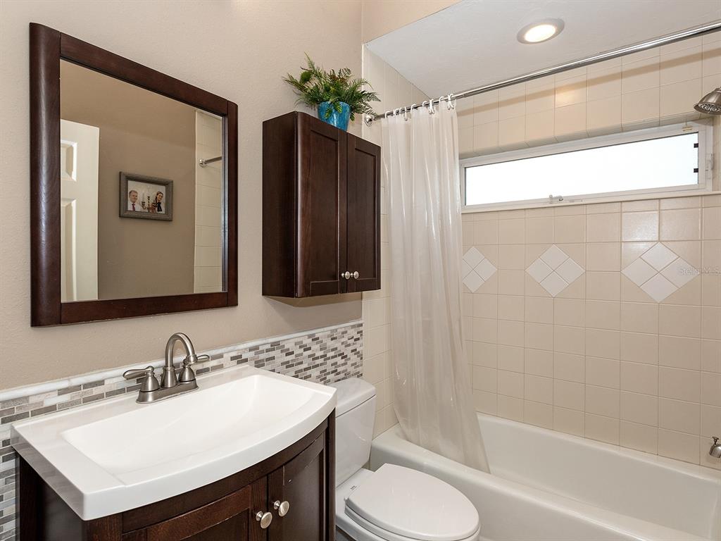 10528 Cheval Place Lakewood Ranch, FL 34202 - Photo 39 of 71 a bathroom with a sink vanity toilet and shower