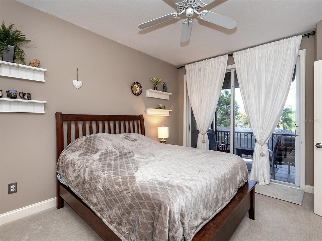 10528 Cheval Place Lakewood Ranch, FL 34202 - Photo 45 of 71 a bed sitting in a spacious bedroom next to a window