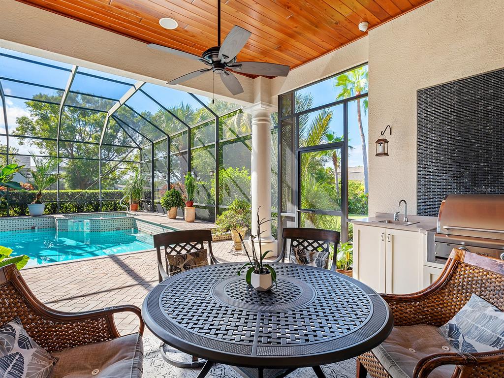 10528 Cheval Place Lakewood Ranch, FL 34202 - Photo 55 of 71 a view of a patio with a table chairs and a yard