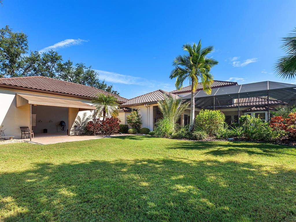 10528 Cheval Place Lakewood Ranch, FL 34202 - Photo 64 of 71 a view of a house with a yard and potted plants