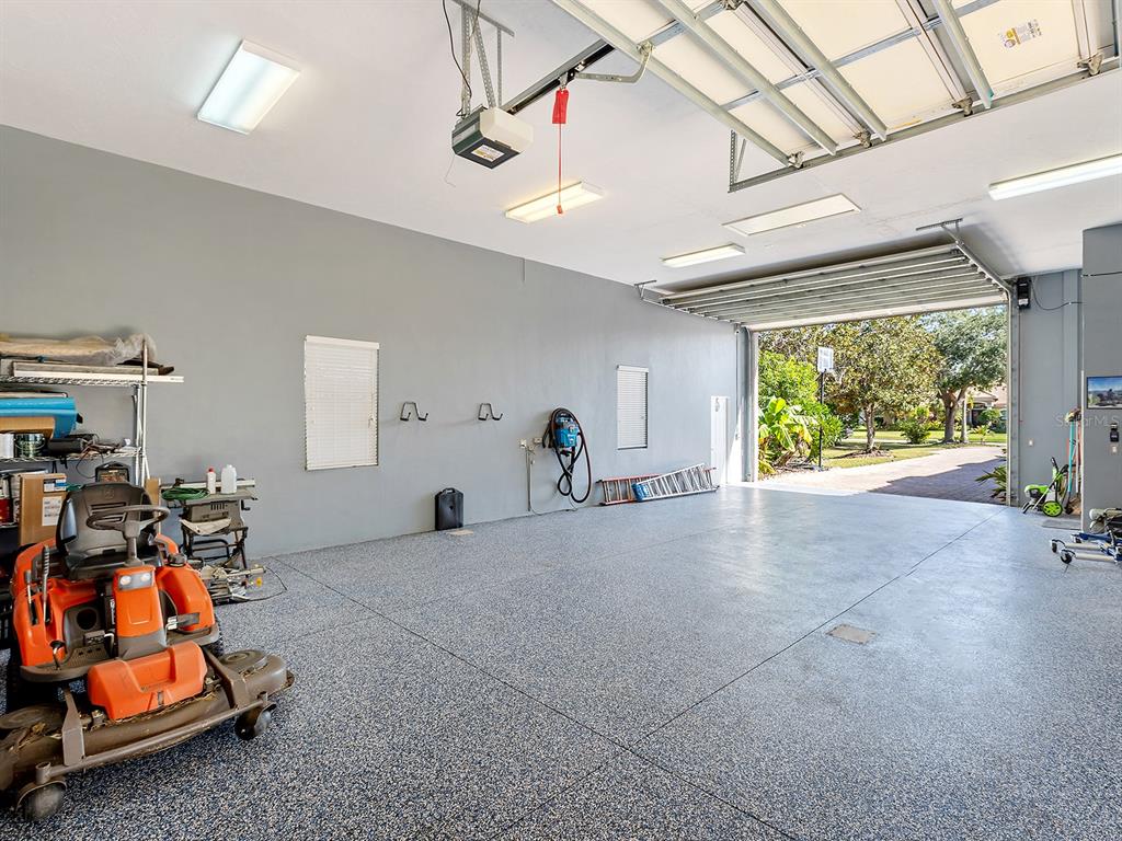 10528 Cheval Place Lakewood Ranch, FL 34202 - Photo 65 of 71 a living room with lots of furniture and a chandelier
