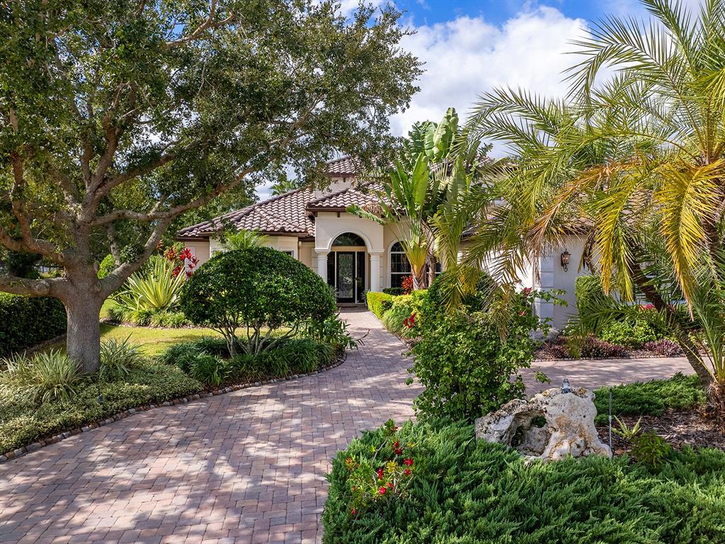 10528 Cheval Place Lakewood Ranch, FL 34202 - Photo 10 of 71 a front view of a house with garden