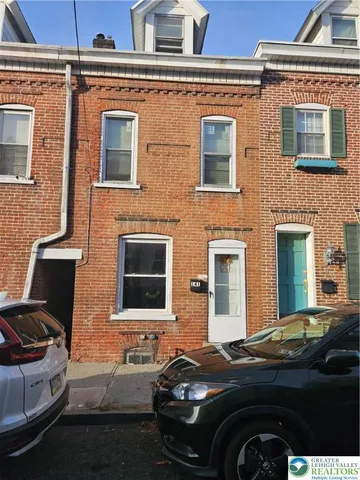 a front view of a house with parking space