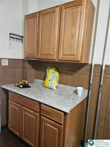 a kitchen with granite countertop cabinets and white appliances