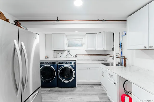 a kitchen with stainless steel appliances a refrigerator sink and cabinets