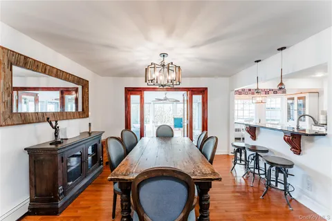 a view of a dining room with furniture window and wooden floor