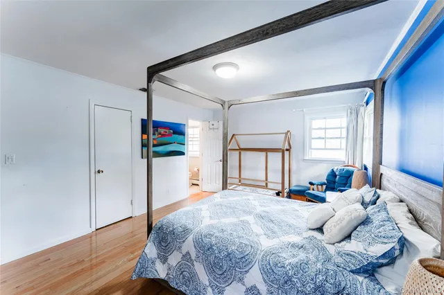 a bedroom with a large bed and a window