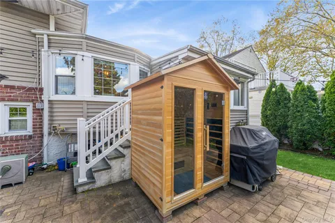 a view of a house with a yard and stairs
