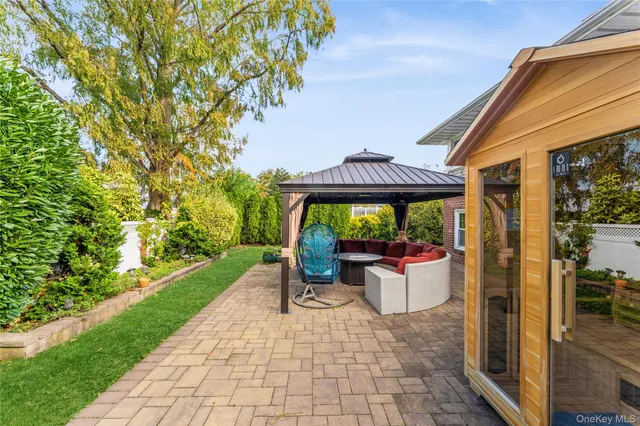 a view of a patio with table and chairs potted plants with wooden floor and fence
