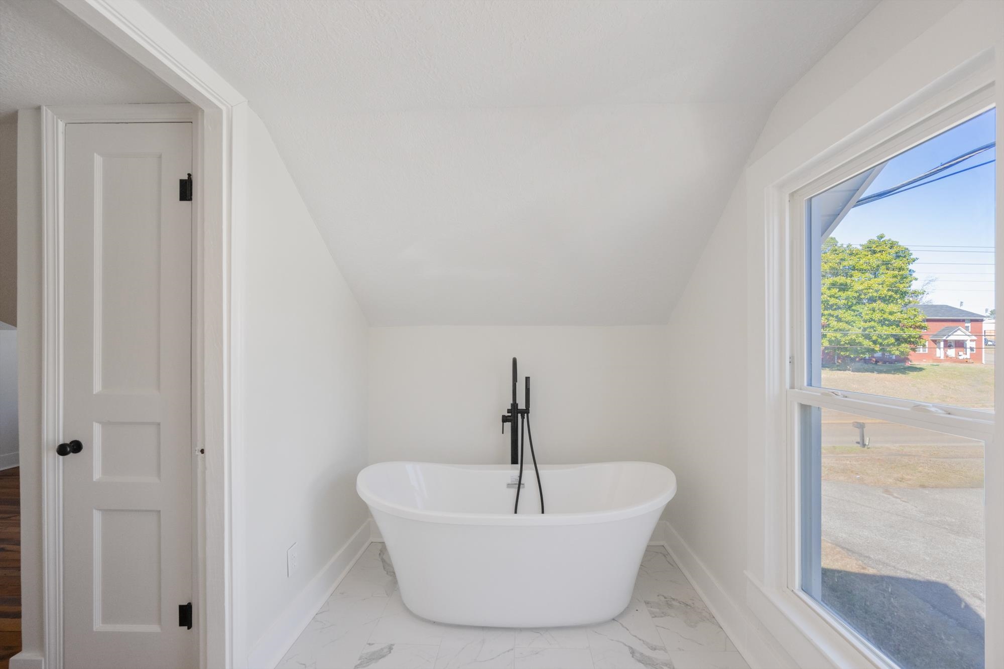 242 Broad Street North Lexington, TN 38351 - Photo 34 of 40 Full bathroom with a soaking tub, light marble finish floors, and vaulted ceiling