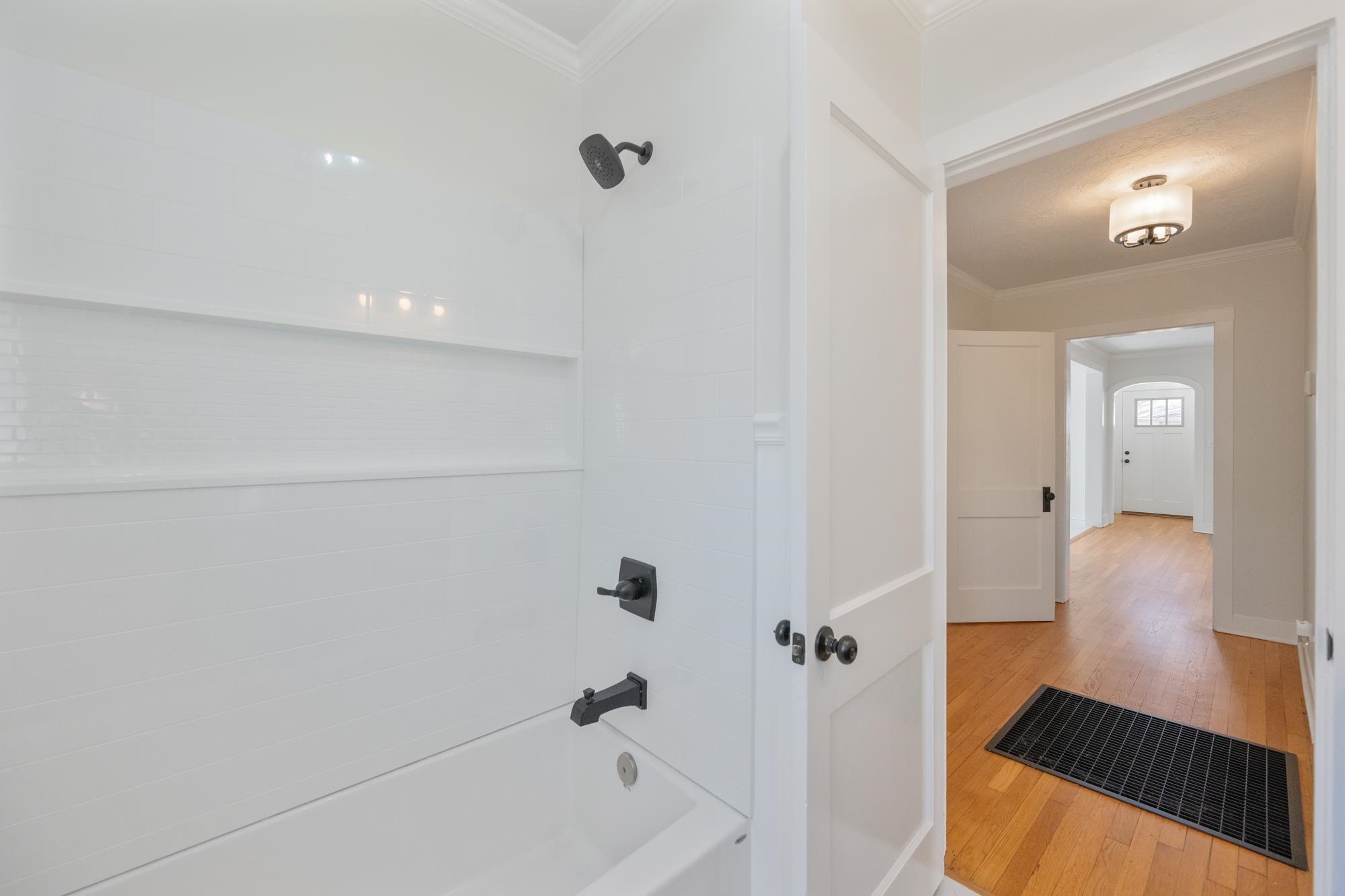 242 Broad Street North Lexington, TN 38351 - Photo 10 of 40 Full bathroom with crown molding, bathing tub / shower combination, and hardwood / wood-style flooring
