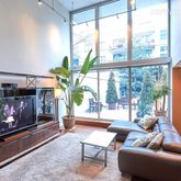 a living room with furniture and a floor to ceiling window
