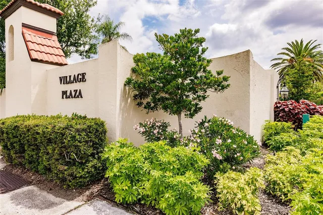 a sign that is in front of flowers