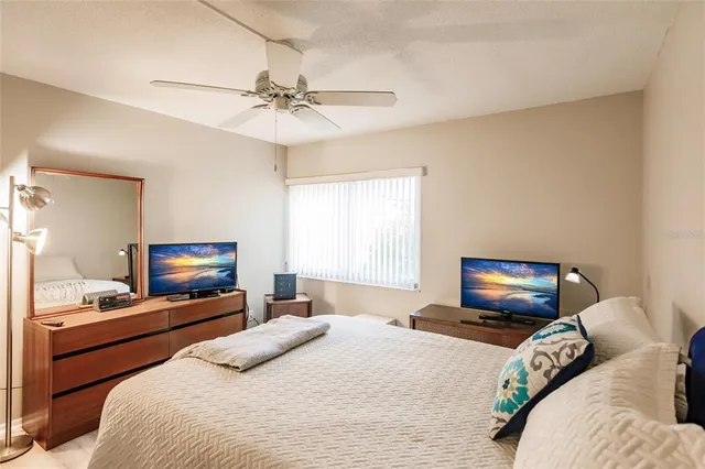 a bedroom with a bed and a tv