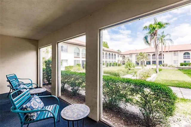 a living room filled with furniture and a large window