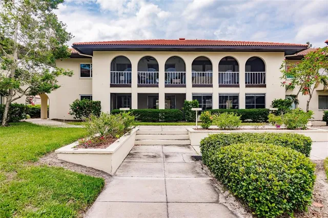a front view of a house with garden and porch