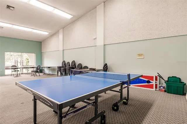 a room with furniture pool table and windows
