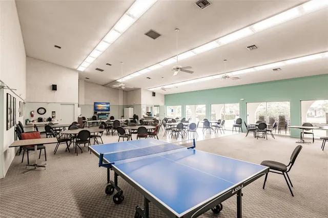 a view of a dining hall with lots of table and chairs