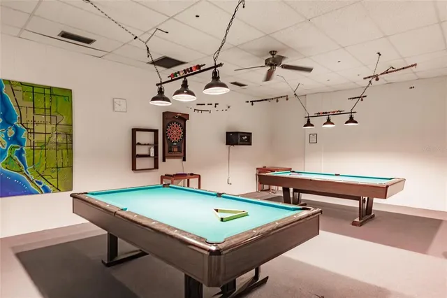 a room with pool table and windows