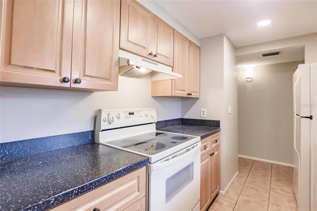 a kitchen with cabinets and a stove top oven
