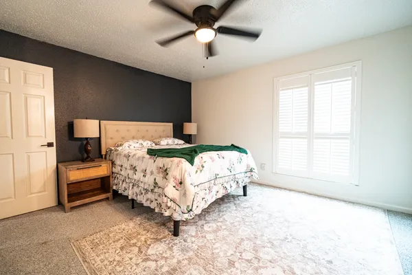 a bed sitting in a bedroom next to a window