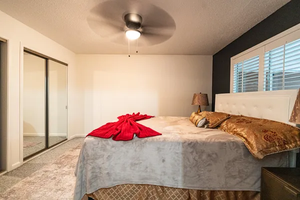 a bedroom with a bed and a chandelier