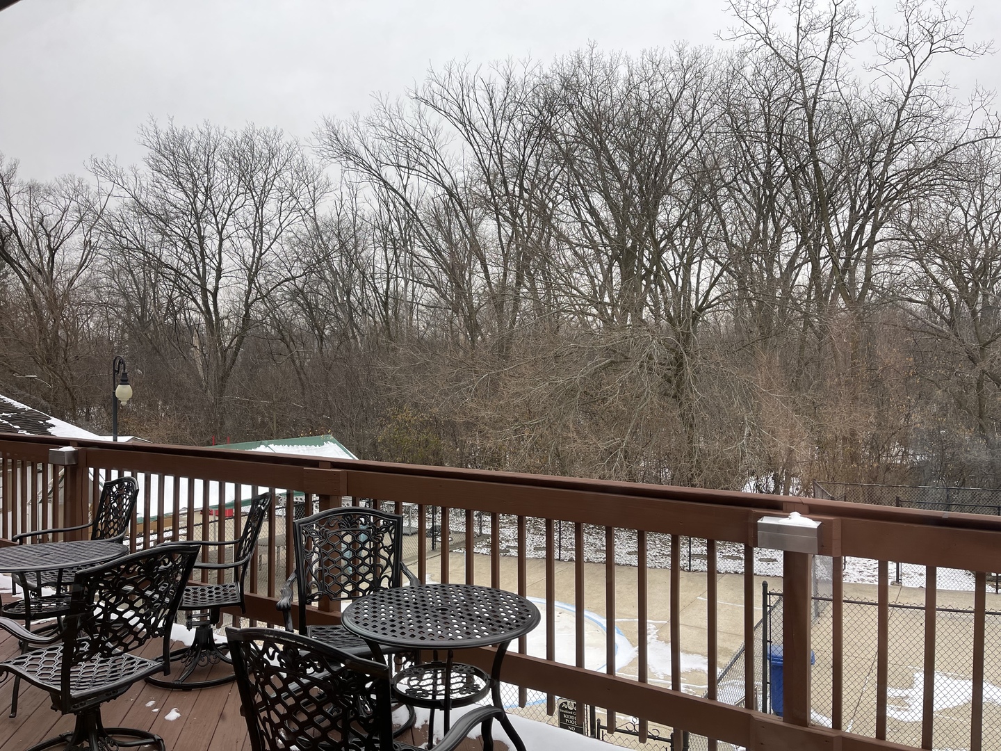 9-s116 S Frontage Road, Unit 27104 Darien, IL 60527 - Photo 13 of 15 a balcony with wooden floor and fence