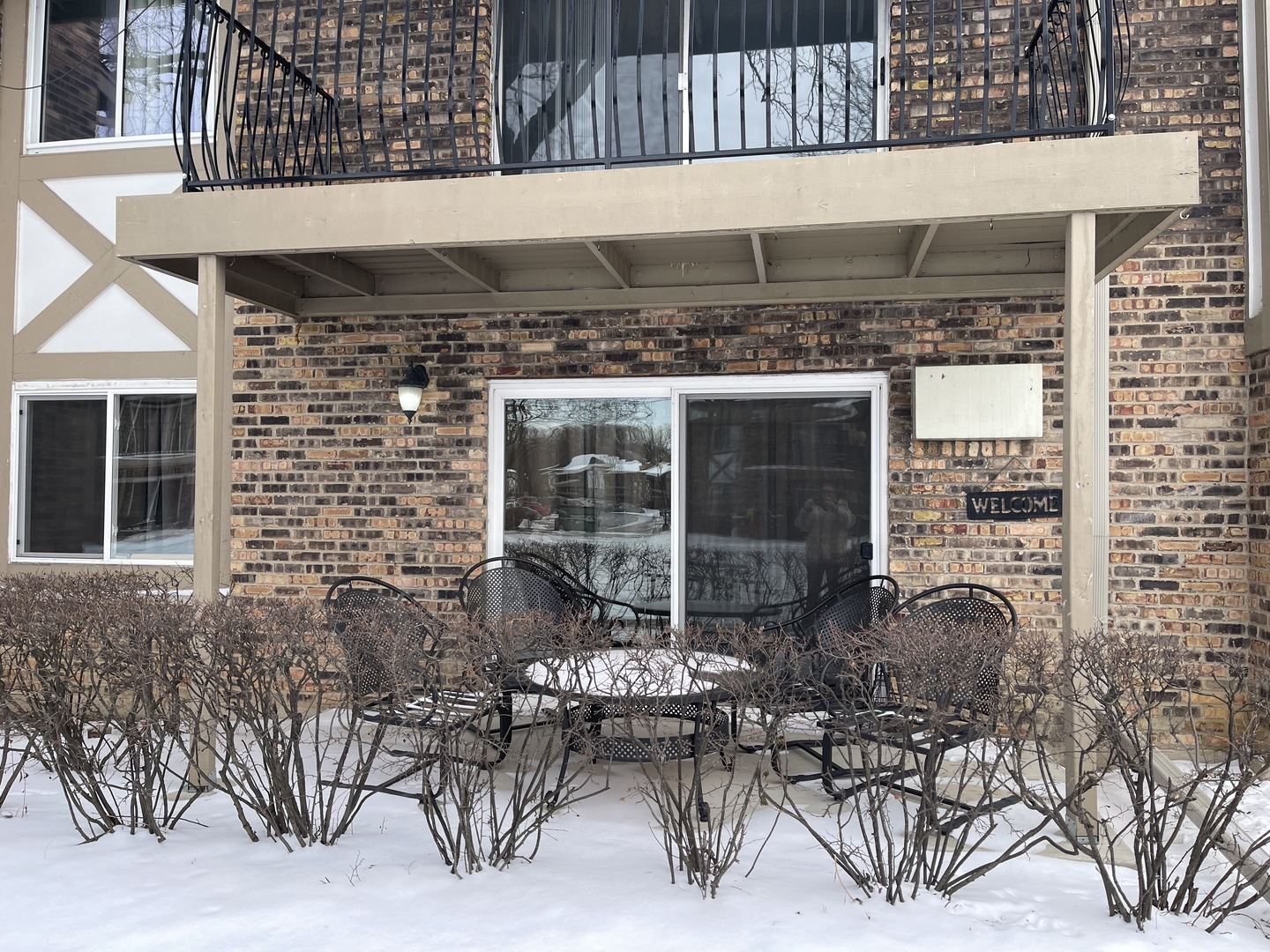 9-s116 S Frontage Road, Unit 27104 Darien, IL 60527 - Photo 2 of 15 a building outdoor space with patio furniture and potted plants