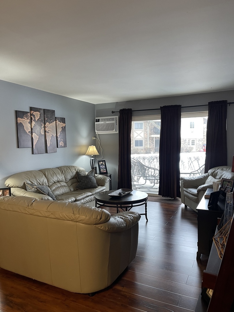 9-s116 S Frontage Road, Unit 27104 Darien, IL 60527 - Photo 4 of 15 a living room with furniture window and wooden floor