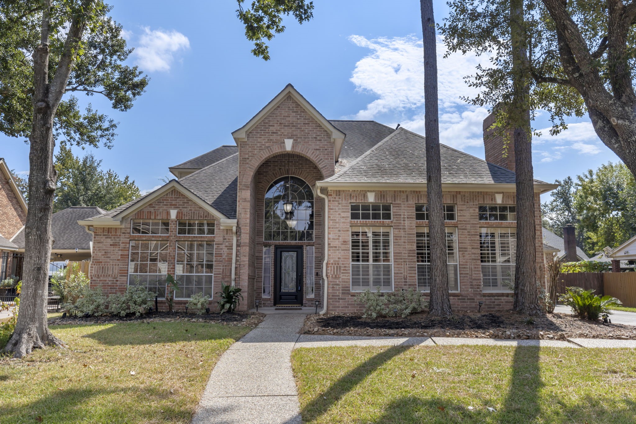 a front view of a house with swimming pool and porch