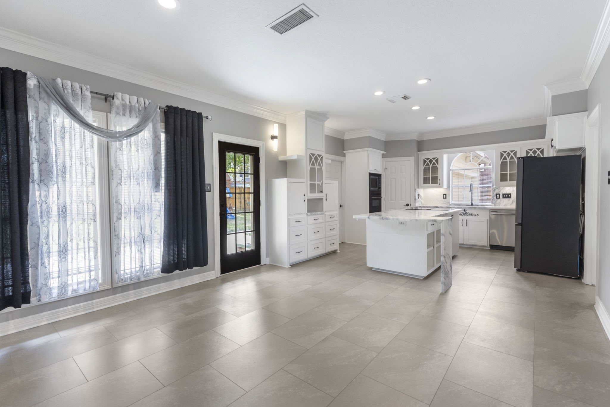3427 Rolling Terrace Drive Spring, TX 77388 - Photo 11 of 36 a large white kitchen with cabinets and a large window