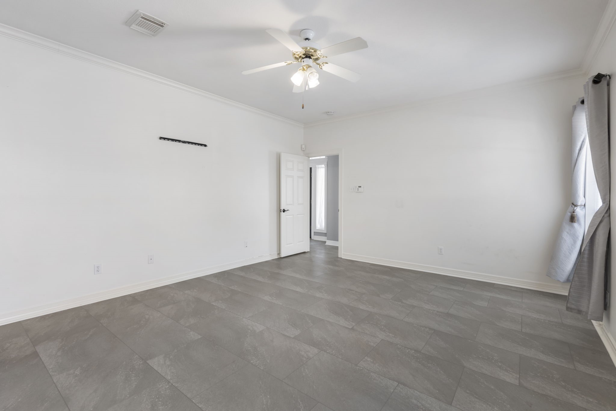 3427 Rolling Terrace Drive Spring, TX 77388 - Photo 19 of 36 an empty room with a ceiling fan and wooden floor